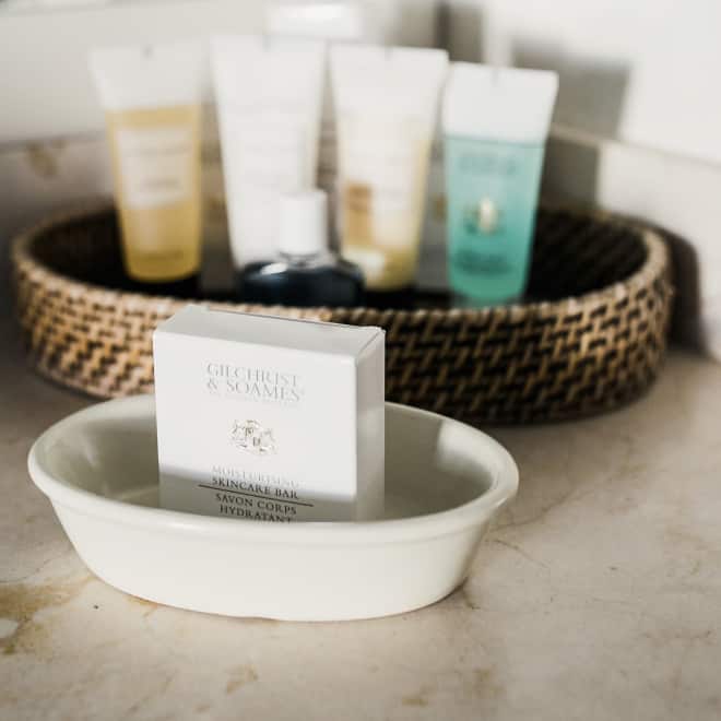 A bathroom counter with a bar of soap and toiletries
