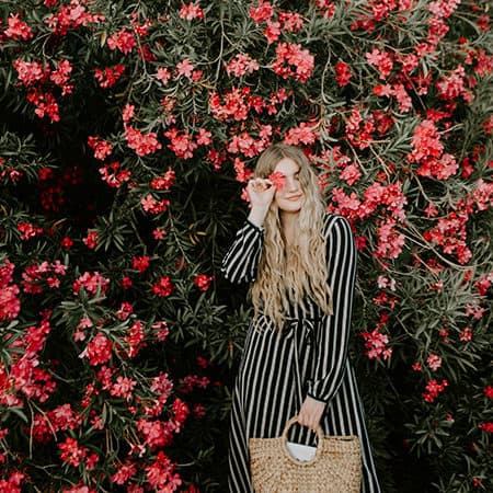 Woman in front of flowers