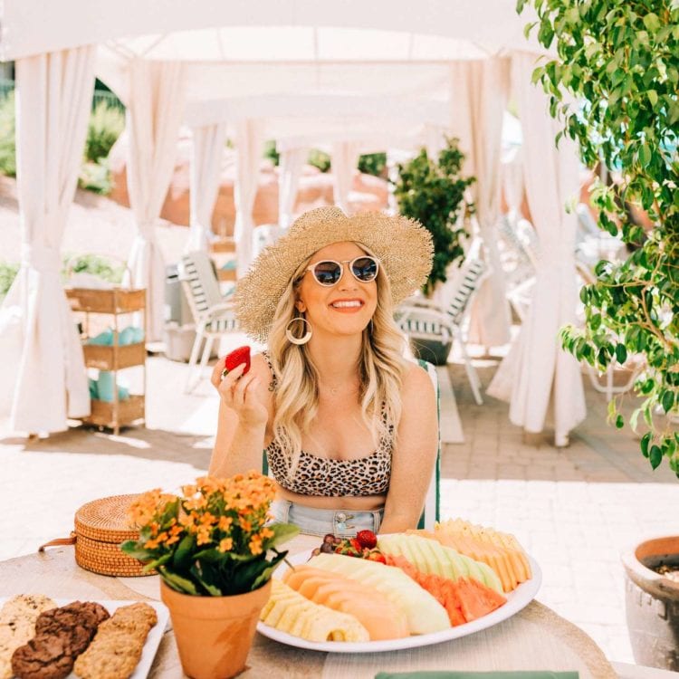 woman eating fruit in a cabana