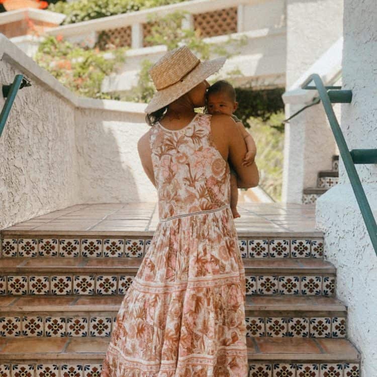 Guest with baby walking up stairs