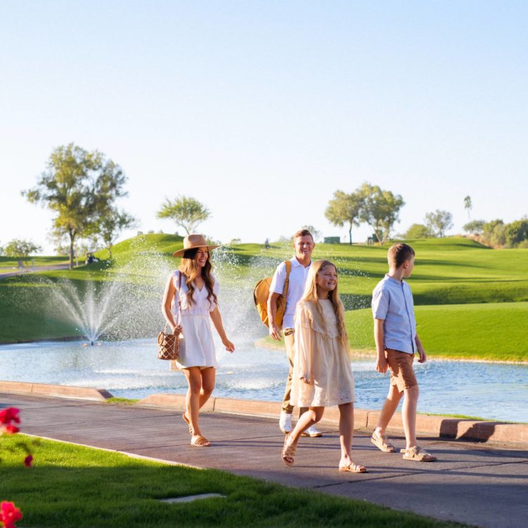 family walking along the water at Arizona Grand
