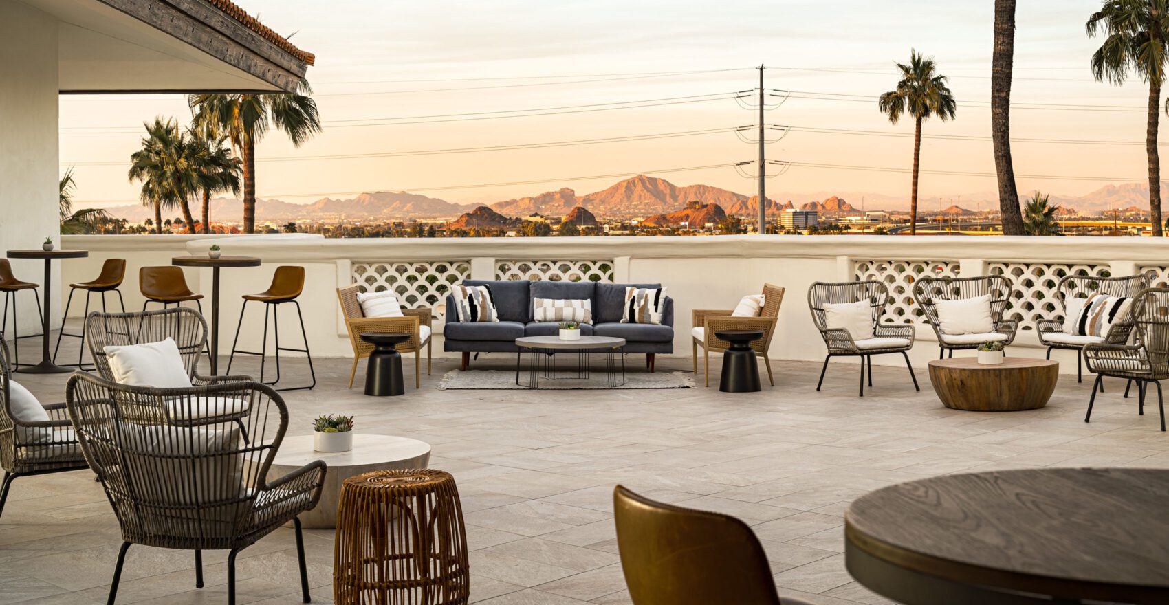 A stylish outdoor lounge area with modern furniture and a mountain view