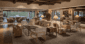 Warm, inviting hotel lobby featuring desert-inspired decor, woven furniture, and views of the golf course patio.